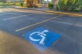 Handicapped parking space at a parking lot outside a building on a sunny day Royalty Free Stock Photo