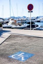 Handicapped parking spot, blue square on asphalt Royalty Free Stock Photo