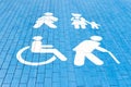 Handicapped parking spot, mom with child, elderly person and man with plaster. blue square on asphalt Royalty Free Stock Photo