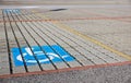 Handicapped parking spot - transportation infrastructure road markings and sign.