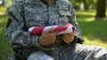 Handicapped peacekeeper holding american flag, country pride, sacrificed hero