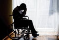 Handicapped Sad Man sitting on wheelchair in empty room Royalty Free Stock Photo