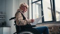 handicapped senior man in wheelchair reading Royalty Free Stock Photo