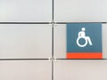 Handicapped sign, detail of an information signal, handicapped sign on a gray background