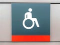 Handicapped sign, detail of an information signal, handicapped sign on a gray background