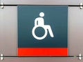 Handicapped sign, detail of an information signal, handicapped sign on a gray background