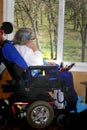 Handicapped woman looking out window