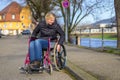 Handicapped woman manoeuvring her wheelchair Royalty Free Stock Photo