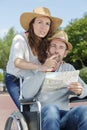 handicapped woman in wheelchair and boyfriend on holidays Royalty Free Stock Photo