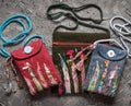 Handicraft, embroidery, handmade bags on a gray old background