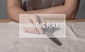 Handicraft word on photo with hands and scissors for sewing