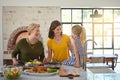 Handing down the recipe to the next generation. a three generational family of women cooking in the kitchen.