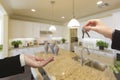 Handing Over New House Keys Inside Beautiful Kitchen Royalty Free Stock Photo