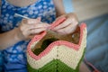 Handiwork. Knitting. Handmade. A girl crochets a colored bag Royalty Free Stock Photo