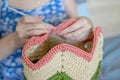 Handiwork. Knitting. Handmade. A girl crochets a colored bag Royalty Free Stock Photo
