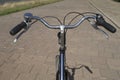 Handle bar on a bicycle seen from the point of view of the cyclist with street on the background Royalty Free Stock Photo