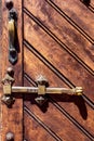 Handle and bolt of an old wooden door. Royalty Free Stock Photo