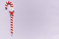 Handle in the form of a Christmas caramel cane on a lilac background. copy space, letter to Santa. Merry Christmas candy can Royalty Free Stock Photo