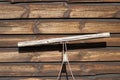 Handle of garden equipment resting against brown wood stained fence Royalty Free Stock Photo