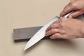 Handle the knife to make a sharp knife with a whetstone. Royalty Free Stock Photo
