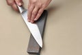 Handle the knife to make a sharp knife with a whetstone. Royalty Free Stock Photo