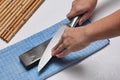 Handle the knife to make a sharp knife with a whetstone. Royalty Free Stock Photo
