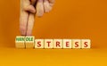 Handle stress symbol. Businessman turns cubes and changes words `stress` to `handle stress`. Beautiful orange background. Medi