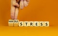 Handle stress symbol. Businessman turns cubes and changes words `stress` to `handle stress`. Beautiful orange background. Medi