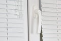 Handle white plastic office windows with shutters Royalty Free Stock Photo