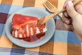 Handle wooden spoon scoop strawberry jam topping on crepe cake