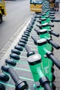 Green scooters lined up in a row