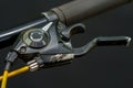 Handlebars of a mountain bike close-up on a black background in the studio. Bicycle repair, replacement of brake handles and