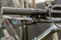 Handlebars of a mountain bike close-up on a black background in the studio. Bicycle repair, replacement of brake handles and