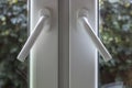 Handles on PVC structures are at an angle and the windows are not completely closed, with dusty glass through which you can see Royalty Free Stock Photo