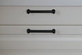 handles on white wooden cabinet drawers Royalty Free Stock Photo