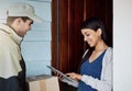 Handling deliveries more efficiently. a young woman using a digital tablet to sign for her delivery from the courier.