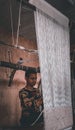 Handloom worker stitching a carpet for customers