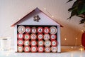 Handmade advent calendar house made from toilet paper rolls and carton.