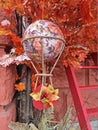 Aerostat hanging on an artificial autumn tree with a ladder