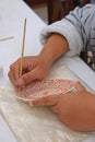 Handmade art of painting porcelain plate using brush