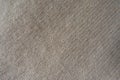 Handmade beige knitted fabric diagonally, from above