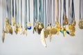 Handmade brass jewelry hang on the laces on the stand at the fair Royalty Free Stock Photo