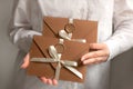 Handmade bronze paper envelope of discount card or voucher in woman hands. Gift certificate is the best present