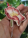 Handmade brooch embroidered with spring flowers - pink wild rose Royalty Free Stock Photo