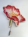 Handmade brooch embroidered with spring flowers - pink wild rose Royalty Free Stock Photo