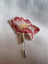 Handmade brooch embroidered with spring flowers - pink wild rose Royalty Free Stock Photo