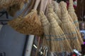 Handmade broom in front of the store selling cleaning products. Other cleaning products