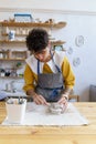 Handmade business. Young female artist creating unique handcrafted ceramics in own pottery studio