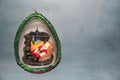 Handmade candle, inside Santa Claus rests in an armchair next to a fireplace. on a gray background with space for text.