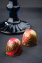 Handmade candy with red and gold splashes on black background. E Royalty Free Stock Photo